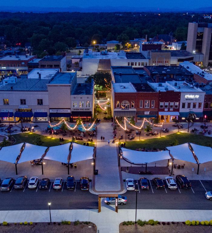 Aerial evening view of downtown Hickory's pedestrian plaza with string lights and outdoor dining
